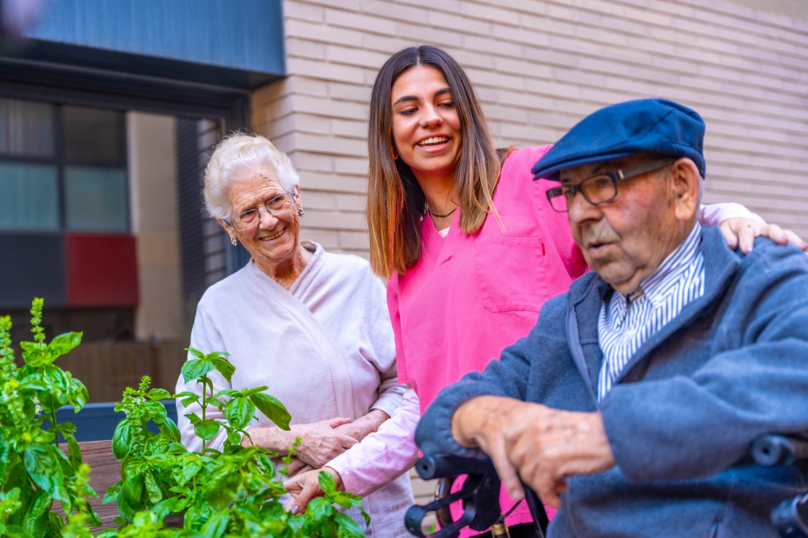 A carer and clients enjoying time together in the garden