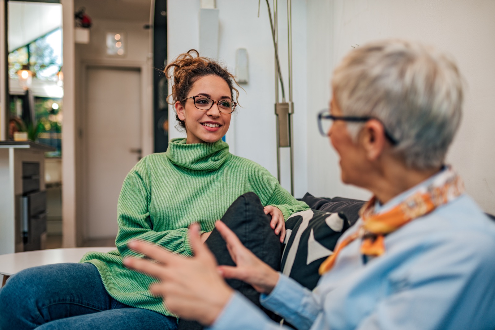 A carer chatting with an older woman at home