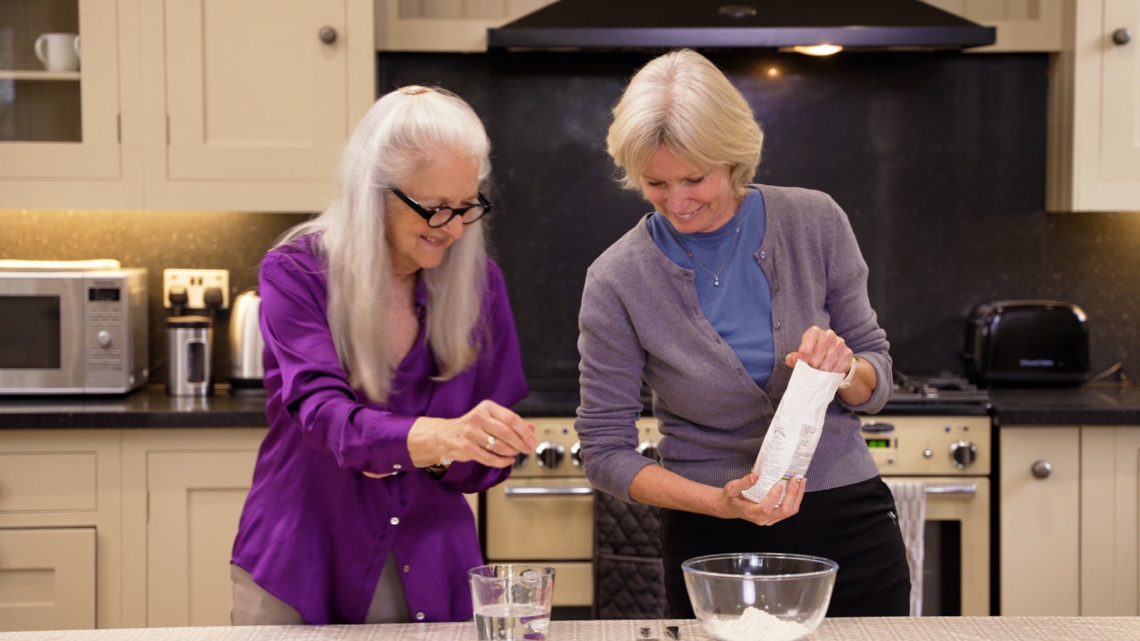 A carer supporting a client in the kitchen
